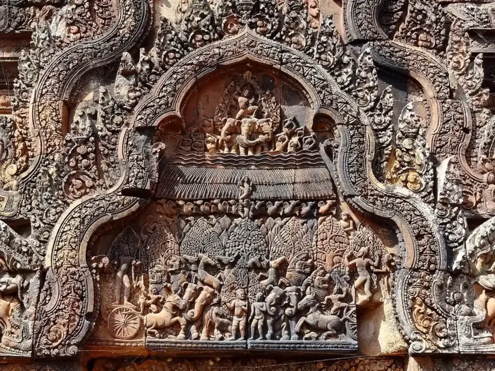 A red sandstone pediment carved with Indra on his elephant at Banteay Srei, added on longer Angkor Wat tours