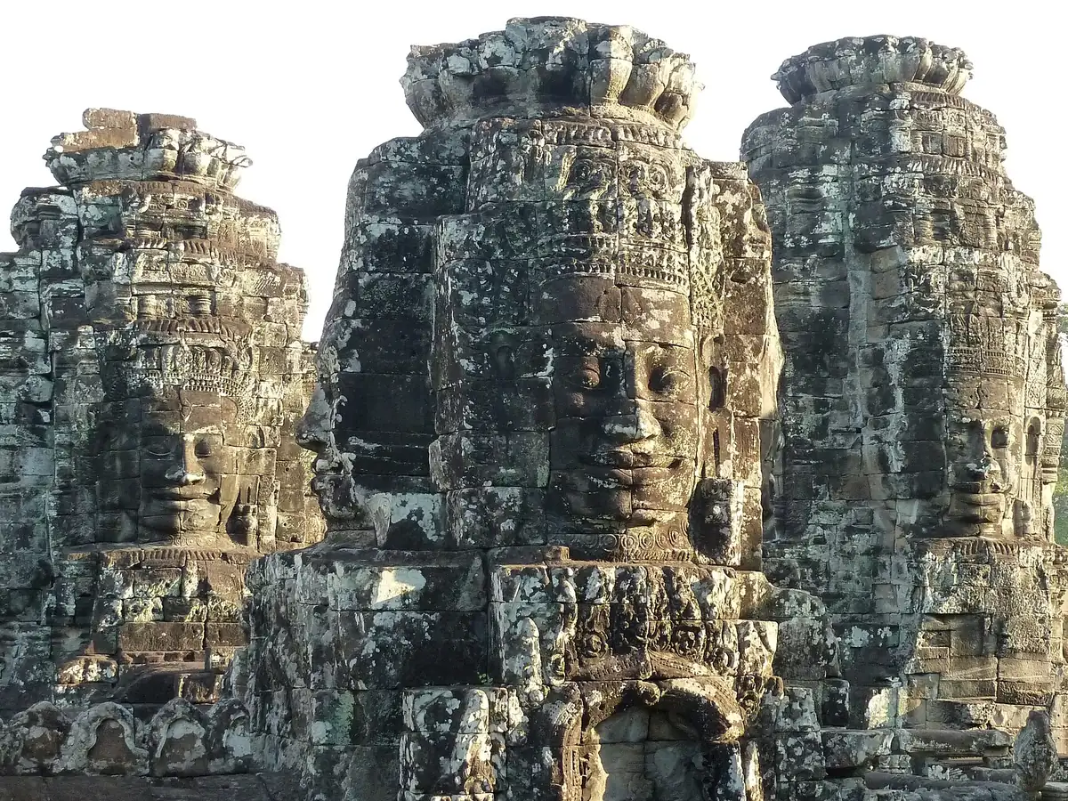 Smiling stone faces carved on the towers of the Bayon in Angkor Thom, a stop on most Angkor Wat tours
