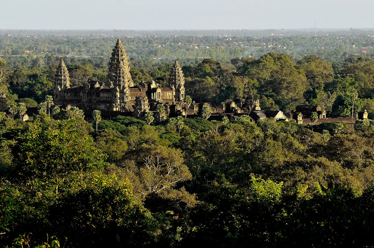 Angkor Wat seen across the forest canopy from the Phnom Bakheng hilltop, seen on Angkor Wat tours from Siem Reap