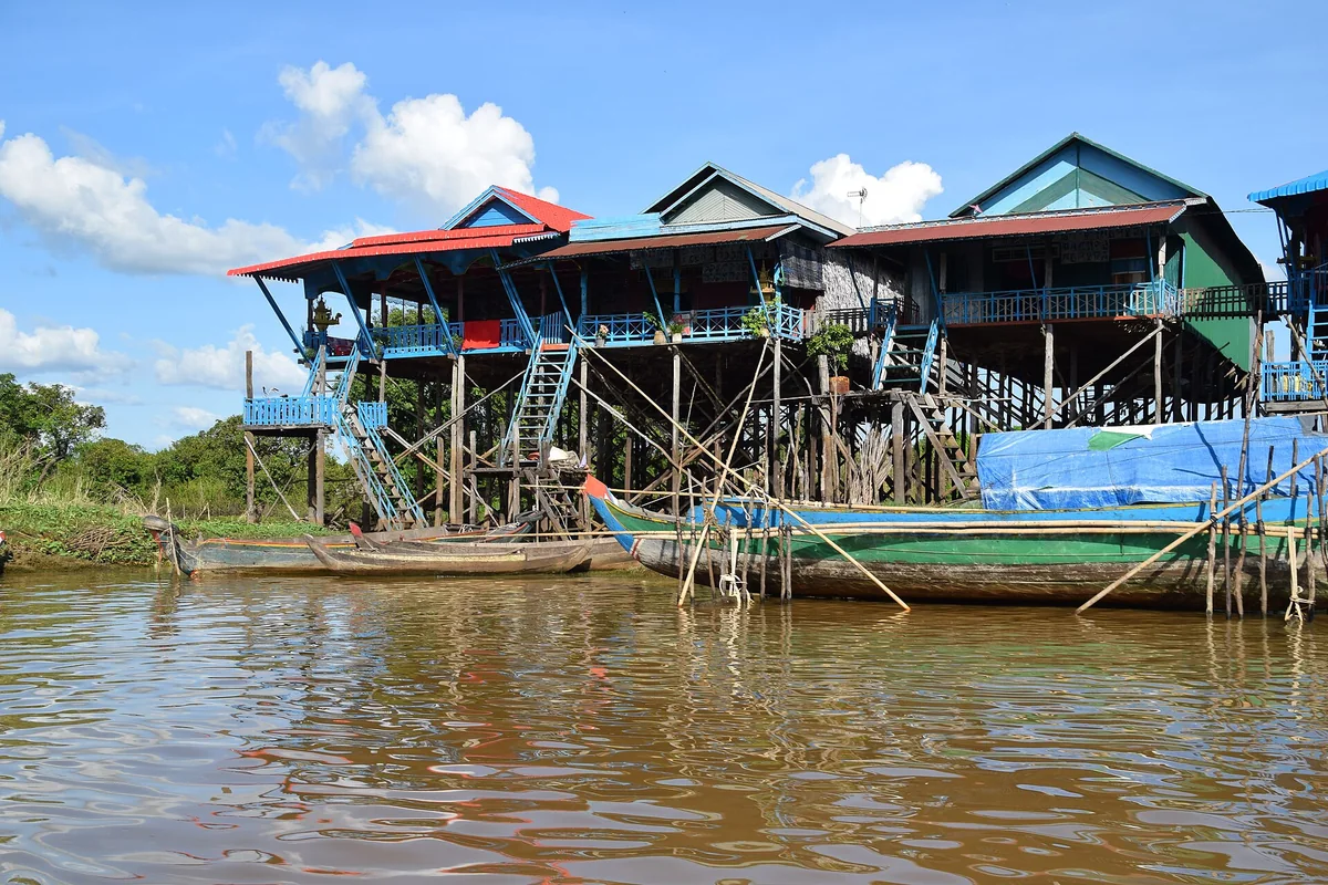 Stilt houses and boats on the water at Kampong Phluk, seen on Angkor Wat tours from Siem Reap